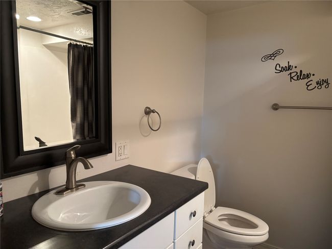 Bathroom featuring vanity, toilet, and a shower with shower curtain | Image 24