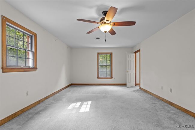 Empty room featuring light colored carpet and ceiling fan | Image 25