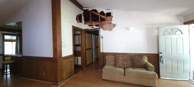 Sitting room featuring a wainscoted wall and wood finished floors | Image 5