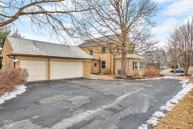view of front of property featuring a garage and brick siding | Image 28