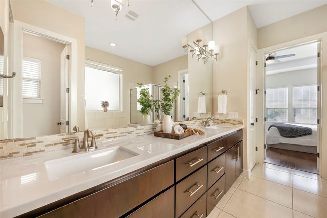 Full bathroom featuring tile patterned flooring, double vanity, tasteful backsplash, a ceiling fan, and ensuite bathroom | Image 14
