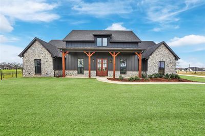 View of front of property with a front yard and french doors | Image 1