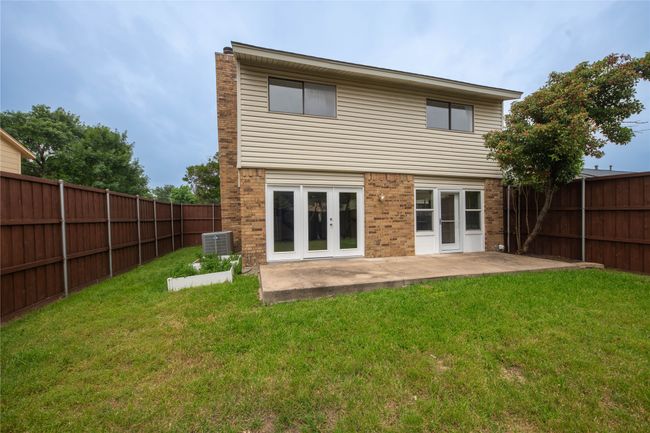 Back of house featuring cooling unit, a patio, brick siding, french doors, and a chimney | Image 35