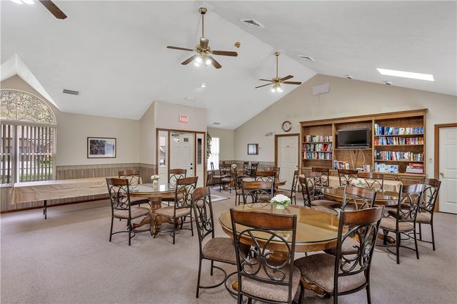 Contemporary Clubhouse Offers Stocked Bookshelf, Tables/Chairs for Socializing or Parties. | Image 32