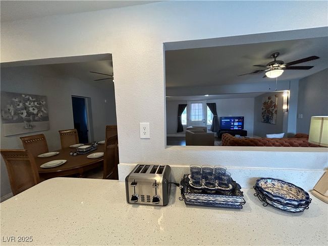 Kitchen featuring ceiling fan and light countertops | Image 9