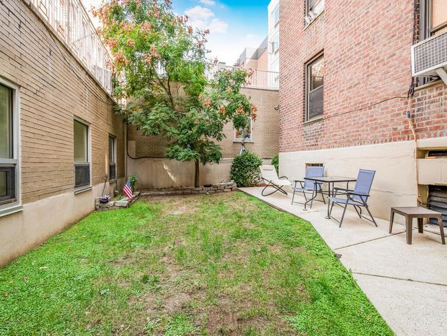 View of green lawn with a patio area | Image 12