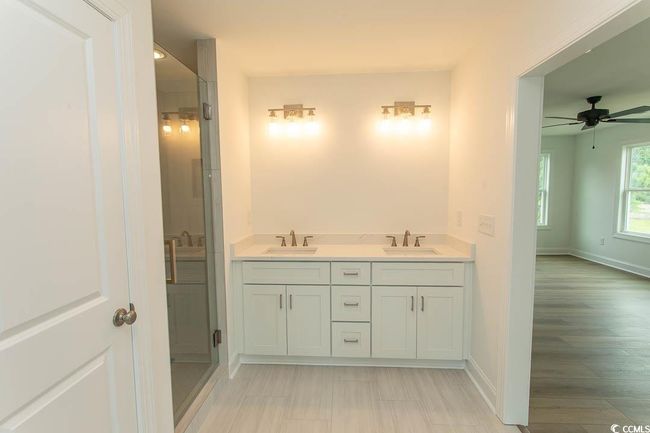 Full bath featuring baseboards, ceiling fan, and double vanity | Image 27