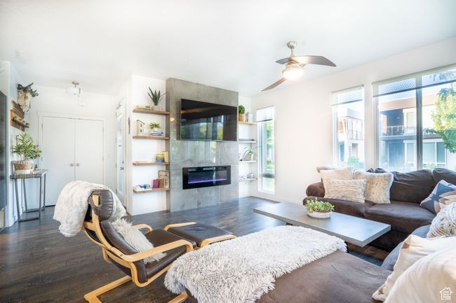 Living room with a custom fireplace, and modern ceiling fan | Image 9
