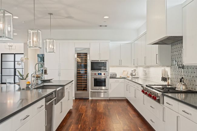 A chef’s dream featuring Wolf appliances, Sub-Zero fridge, and quartz countertops. This kitchen is a centerpiece of luxury, built for both function and flair. | Image 7