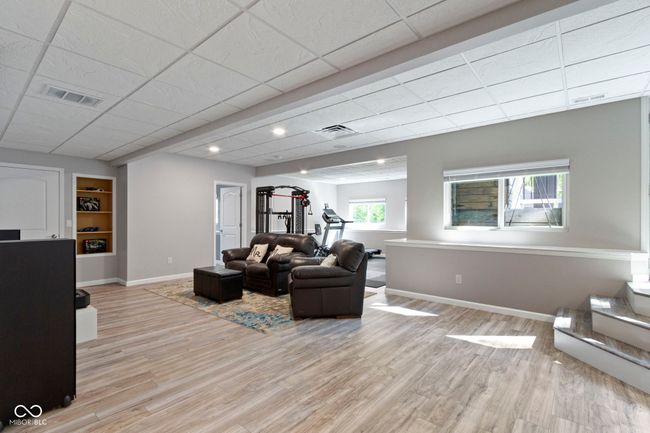 This finished walk out basement has all of the space you need for entertaining, exercising, gaming, movies and even has a bedroom and full bath. Plus, you won't believe the storage space! | Image 51