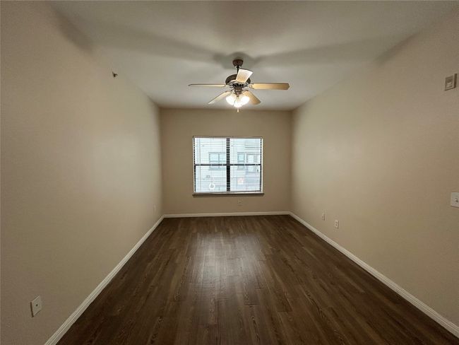 Unfurnished room with ceiling fan, dark wood-type flooring, and baseboards | Image 10