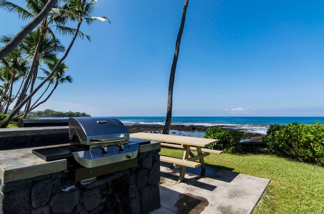Beachfront BBQ area perfect for grilling and gathering at sunset | Image 9