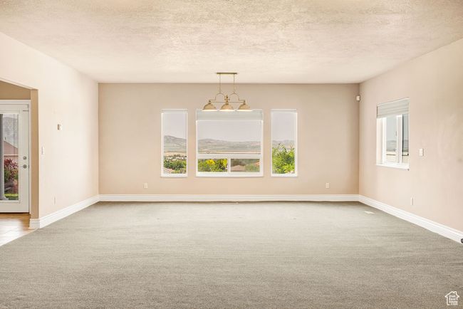 Unfurnished room with carpet, a textured ceiling, and baseboards | Image 27