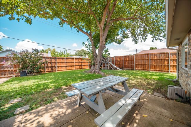 Fenced backyard featuring outdoor dining area and a patio area | Image 26