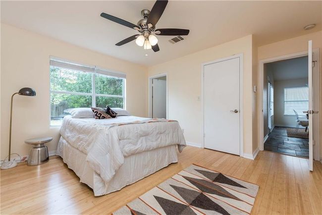 Bedroom with light wood-style flooring and a ceiling fan | Image 9