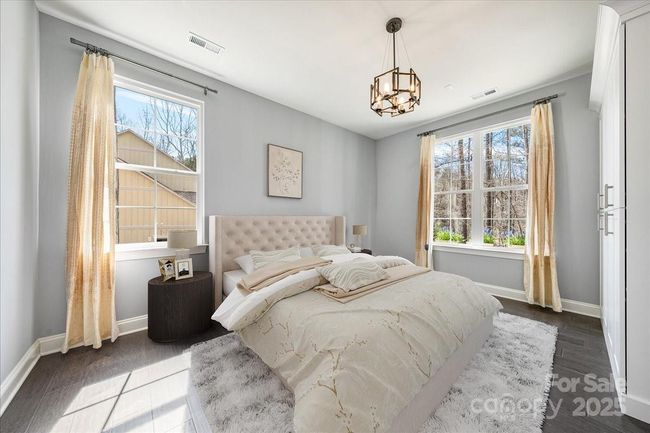 Second bedroom on main level with brand new custom closet system by Impact Fine Design. Photo is virutally staged to show both options for this bedroom. | Image 5