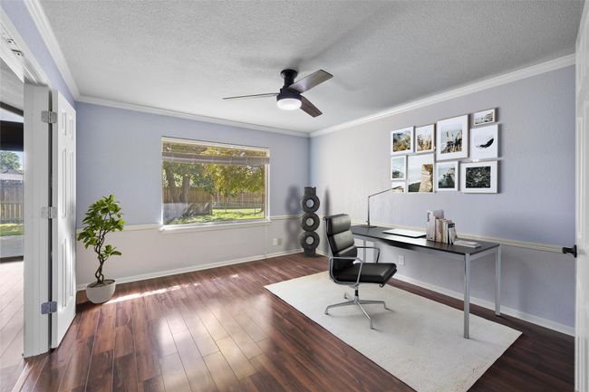 Office space featuring a textured ceiling, a ceiling fan, wood finished floors, crown molding, and baseboards | Image 6