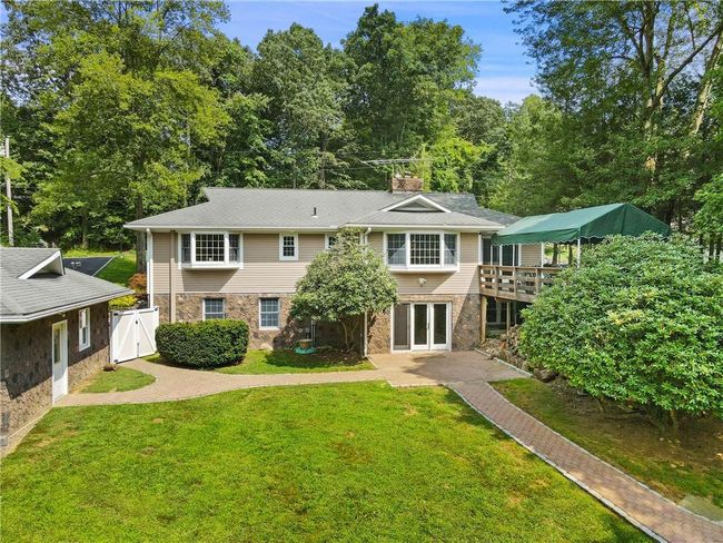 Back of house with a deck and a lawn | Image 28