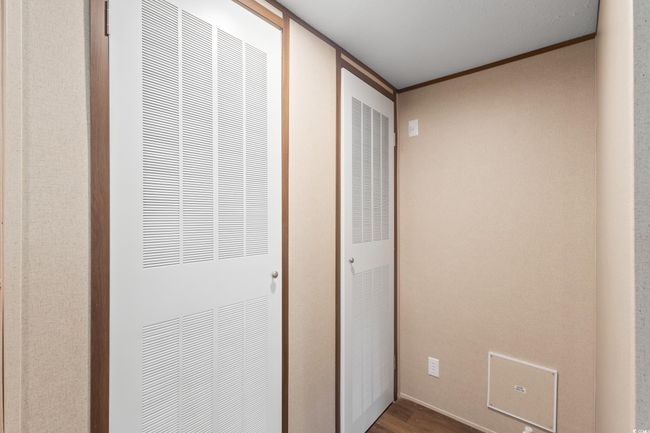 Hallway with a heating unit, wood finished floors, and crown molding | Image 28