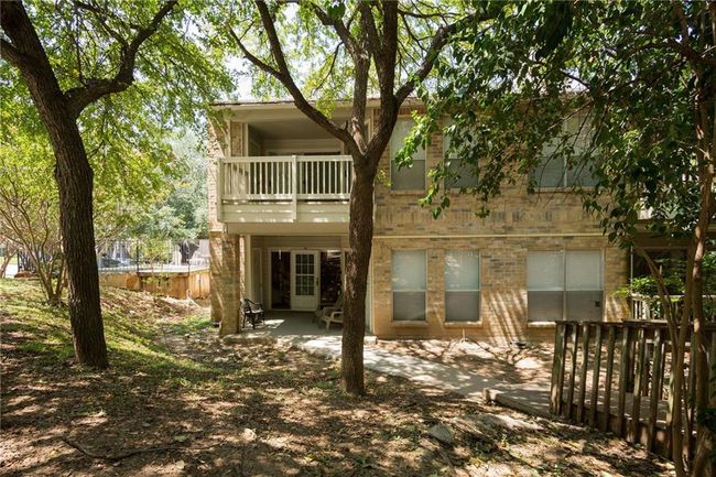Rear view of property featuring a balcony, fence, and a patio area | Image 25