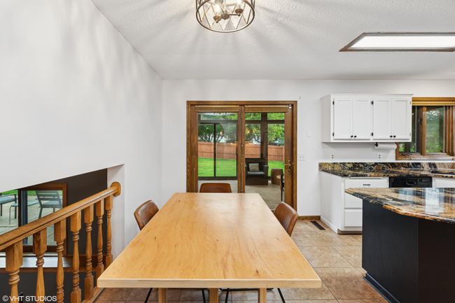 Informal dining with views of the 3-season porch and a spacious backyard—perfect for everyday moments | Image 19