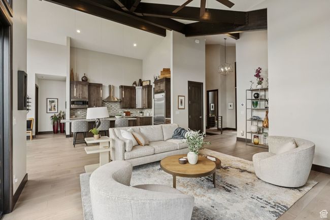 Living area featuring high vaulted ceiling, light wood-type flooring, ceiling fan, and beamed ceiling | Image 15