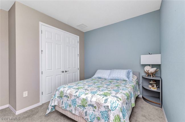 Carpeted bedroom with a closet and baseboards | Image 12