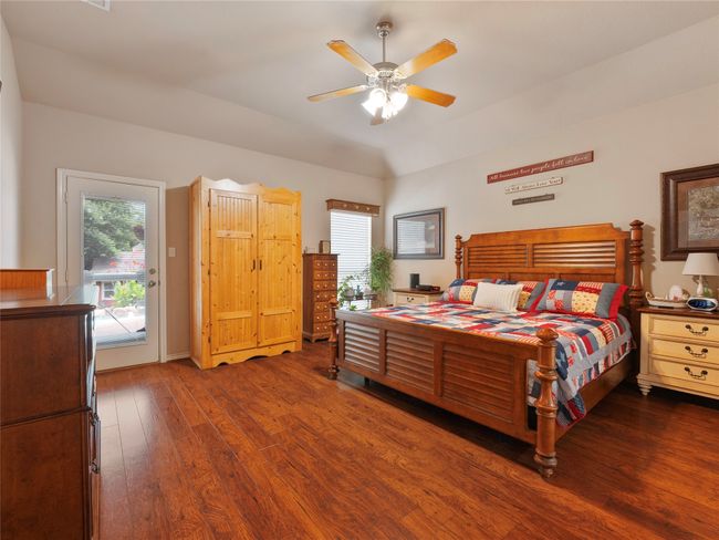 Bedroom with wood-type flooring, access to outside, multiple windows, and ceiling fan | Image 16