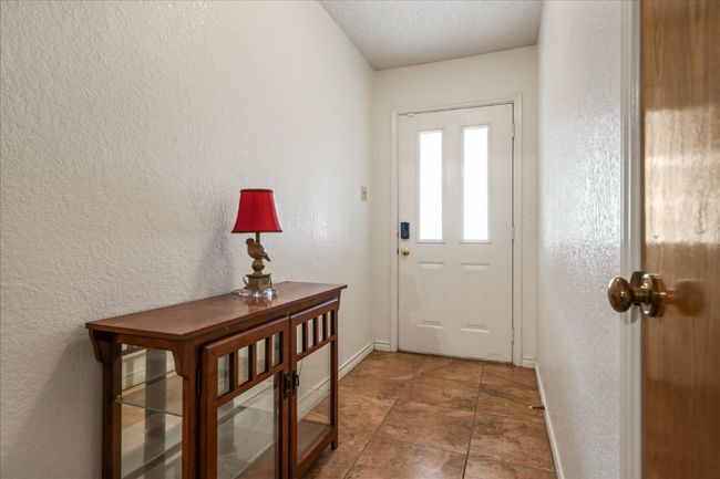 Entrance foyer featuring a textured wall and a textured ceiling | Image 5