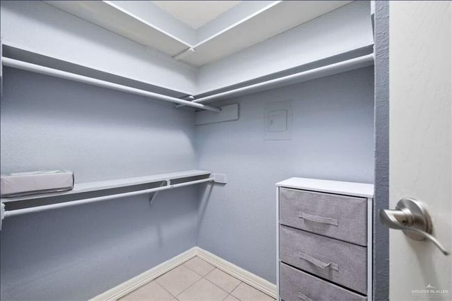 Walk in closet with light tile patterned floors | Image 9