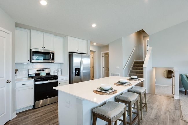 Just 8 steps up and 8 steps down from the main level to 4 bedrooms, 3 bathrooms, and a spacious lower level rec room! Photo of model home, colors and selections shown may vary | Image 4