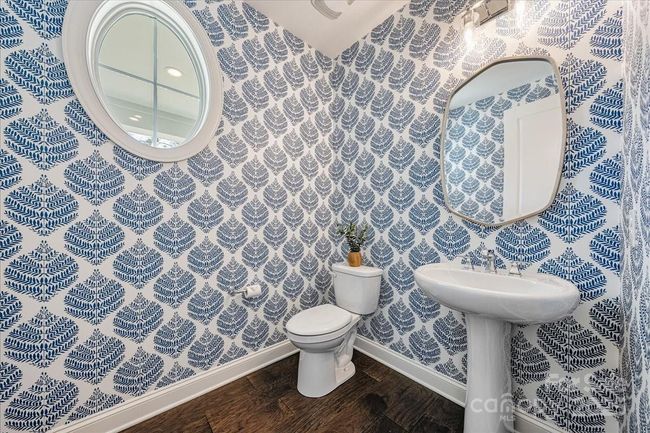 Main Level half bath with custom wall paper added post-build completion | Image 7