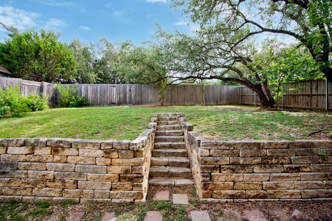 There's a large flat yard for the kids to play and the dogs to run. | Image 5
