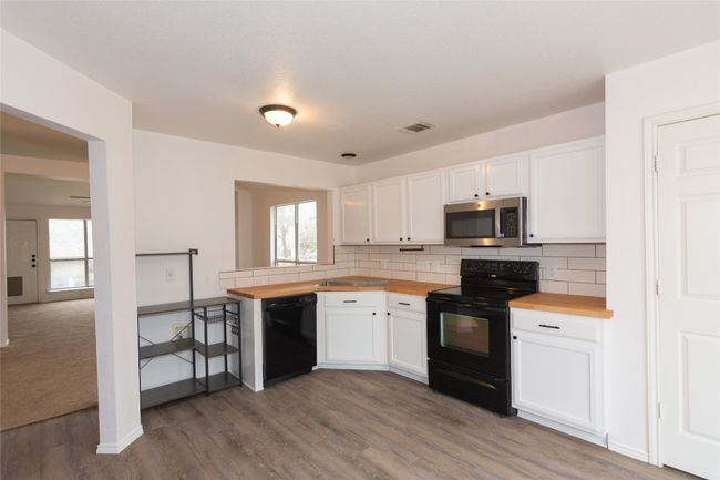 Kitchen features freshly painted white cabinets | Image 5