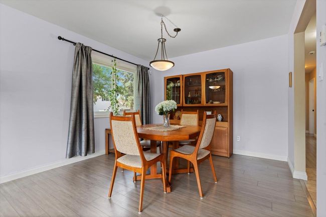 Dining area featuring wood finished floors and baseboards | Image 17