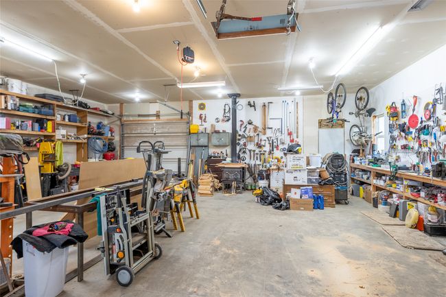 Garage with a workshop area | Image 64