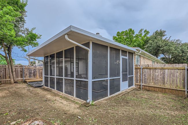 View of outdoor structure featuring a sunroom and a fenced backyard | Image 27