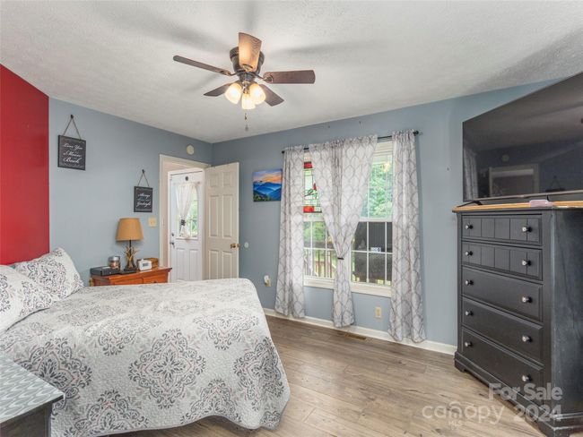 Primary Bedroom with wood/laminate flooring | Image 9