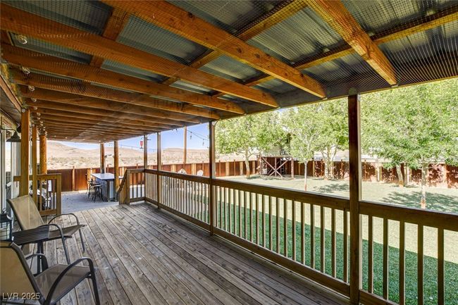 Wooden terrace featuring a fenced backyard and a mountain view | Image 38