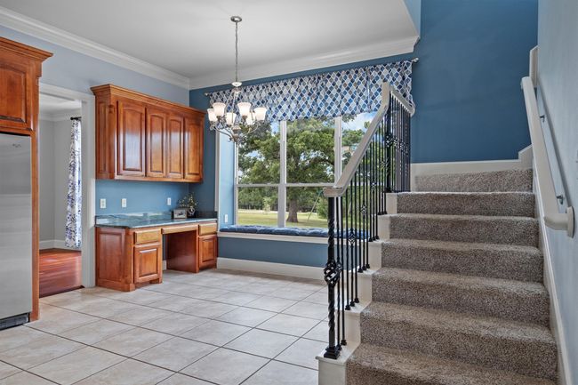This versatile eat-in kitchen space offers room for casual dining and a built-in desk ideal for staying organized. | Image 10