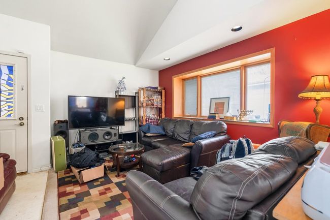 Living room with recessed lighting, a healthy amount of sunlight, light colored carpet, and vaulted ceiling | Image 27