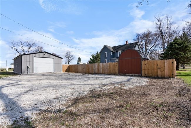 Exterior shop with newly poured gravel, shed, and | Image 32