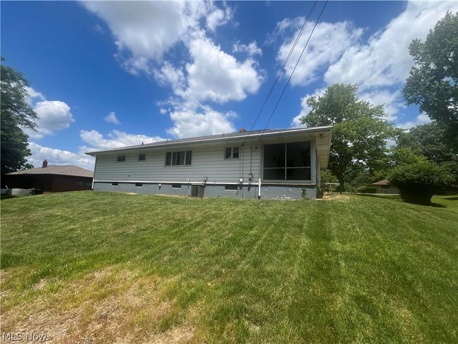 Rear view of house with a lawn | Image 16