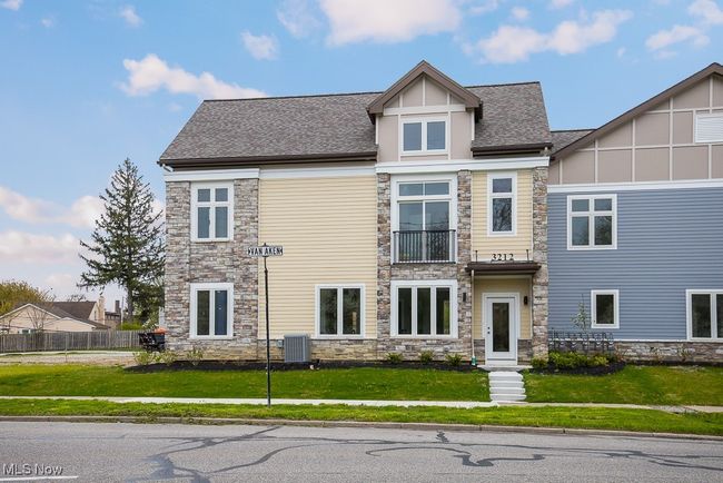 View of front of home featuring a front yard, central AC, and a balcony | Image 33