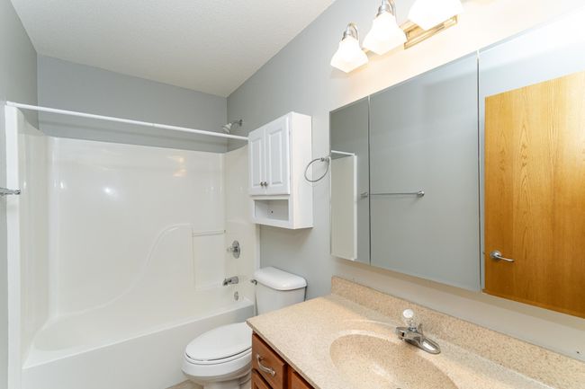 Full bath with hard-surface vanity top and tub/shower. | Image 14