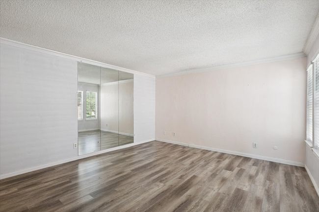 Unfurnished room with crown molding, wood finished floors, and a textured ceiling | Image 14