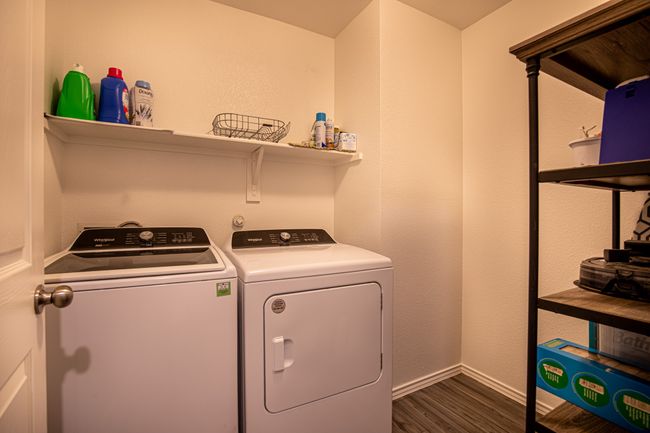 Washroom with separate washer and dryer and dark wood-style flooring | Image 21