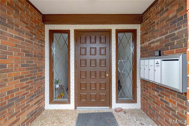 View of exterior entry featuring brick siding | Image 47