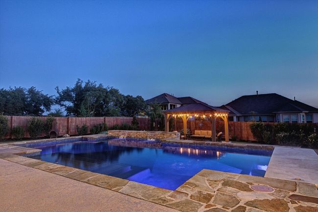 Backyard Oasis with Sparkling Pool, Pergola, and Outdoor Kitchen | Image 37