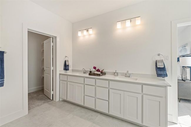 Bathroom with double vanity and tile flooring | Image 21